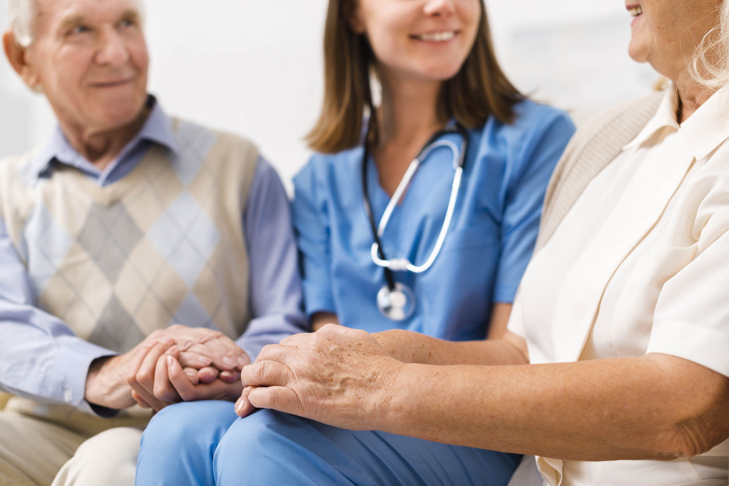 bassa - old-man-woman-sitting-yellow-sofa-with-nurse.jpg